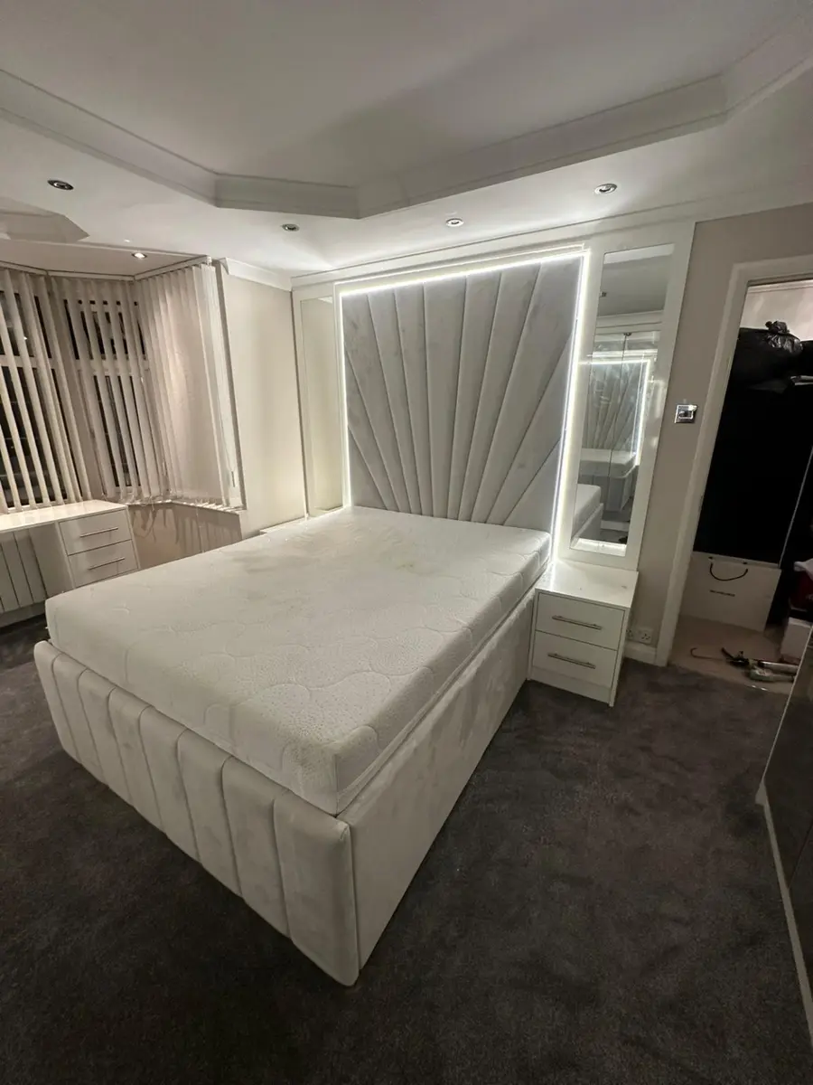 Light grey fan-panel headboard with integrated LED lighting