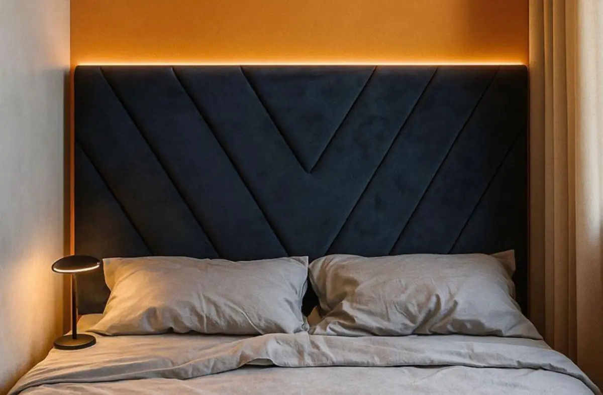 Deep navy bespoke chevron headboard with warm LED lighting