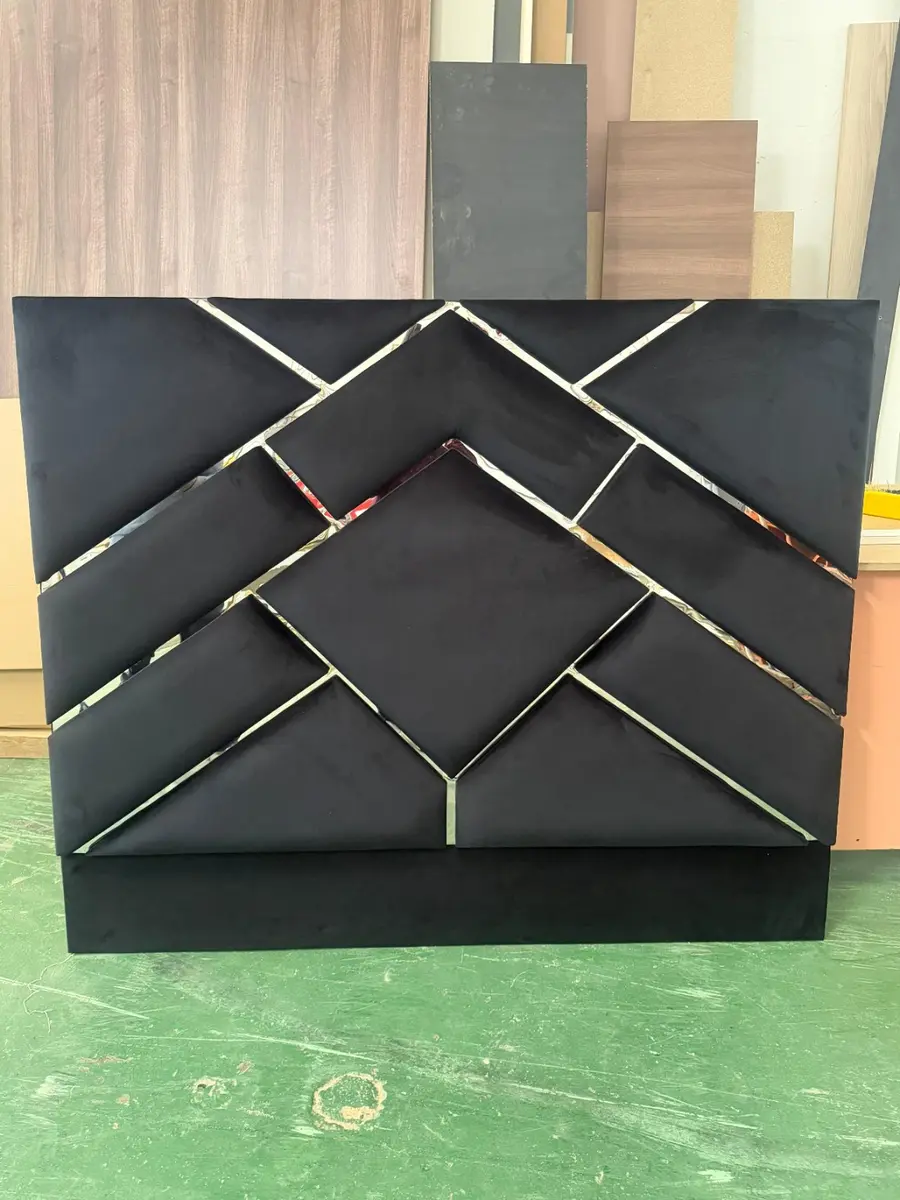 Black geometric headboard with mirrored trim