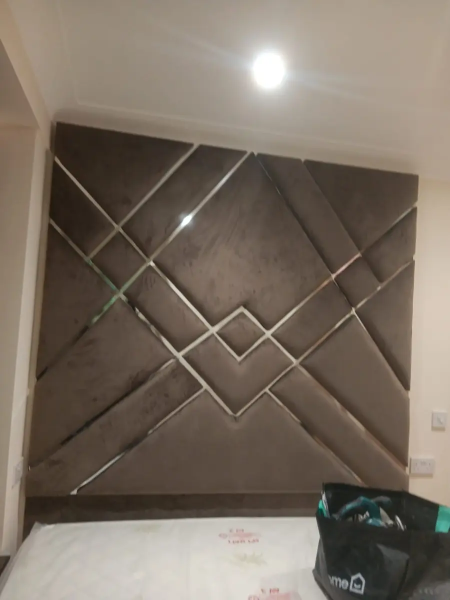 Taupe geometric headboard with metallic trim